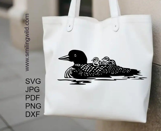 Detailed black vector graphic of a loon mom, digital clipart for cutting, engraving, and creative projects presented on a tote bag