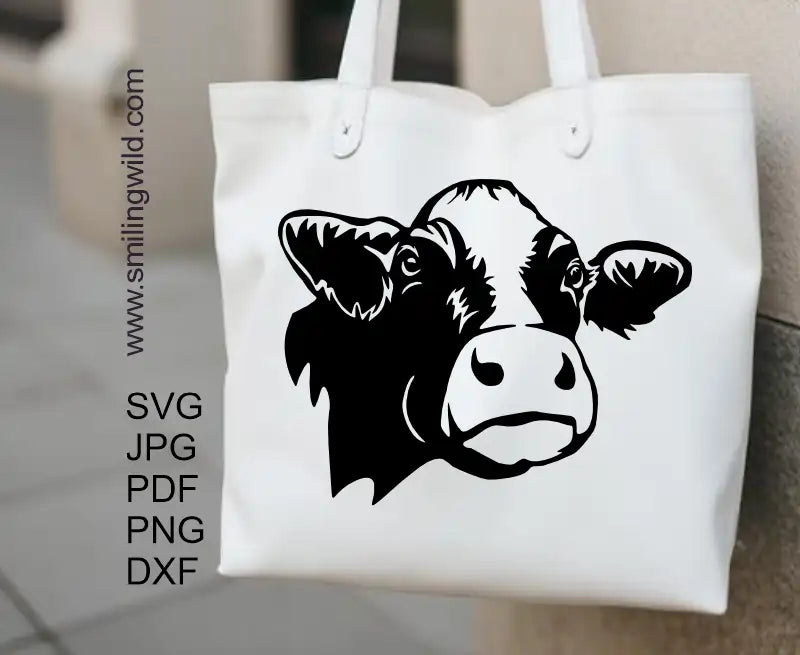 Holstein cow face displayed on a tote bag as a sticker made of a svg and other pouler vector graphic clipart files