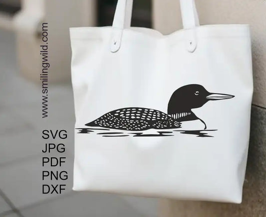 Detailed black vector graphic of a loon, digital clipart for cutting, engraving, and crafting represented on a tote bag